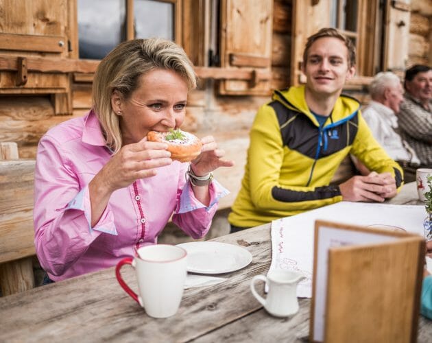 Alexandra eating farmers doughnuts at the Gainschniggalm